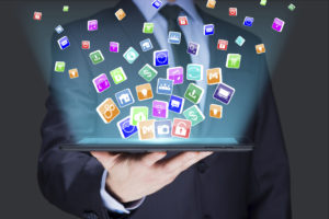Businessman holding a tablet pc with mobile applications icons on virtual screen . Internet and business